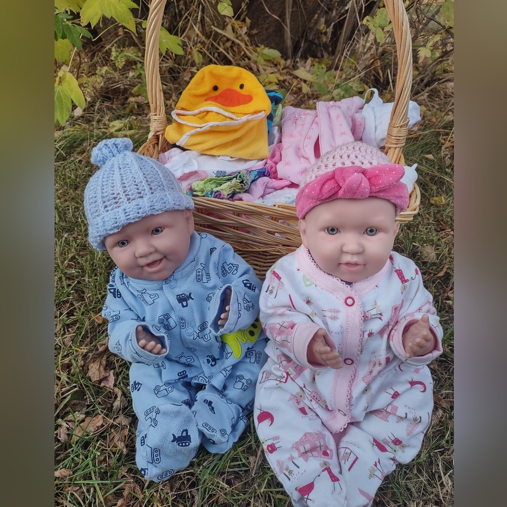 Baby dolls with basket and wardrobe.